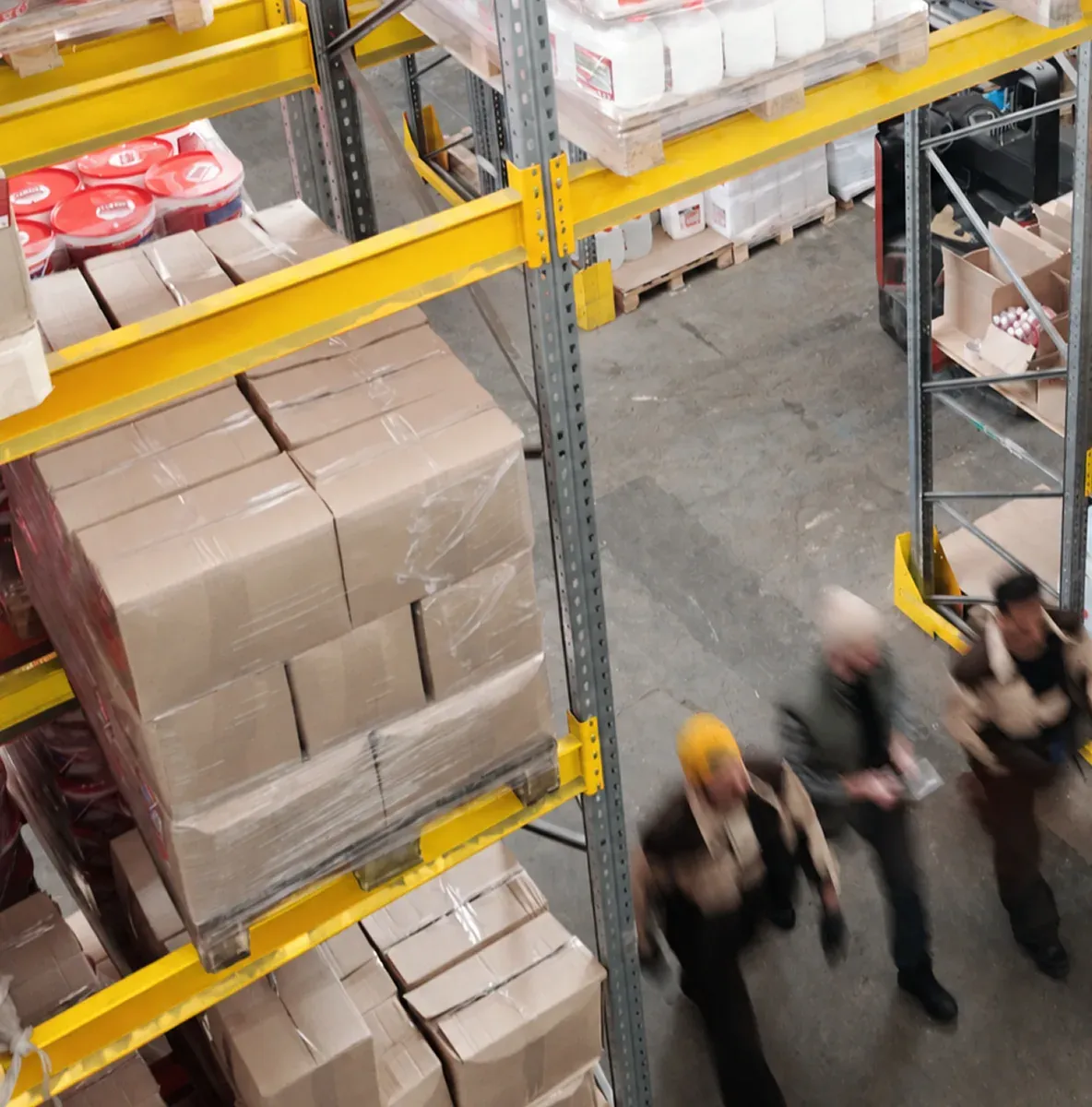 Depot staff walking between racks of parcels